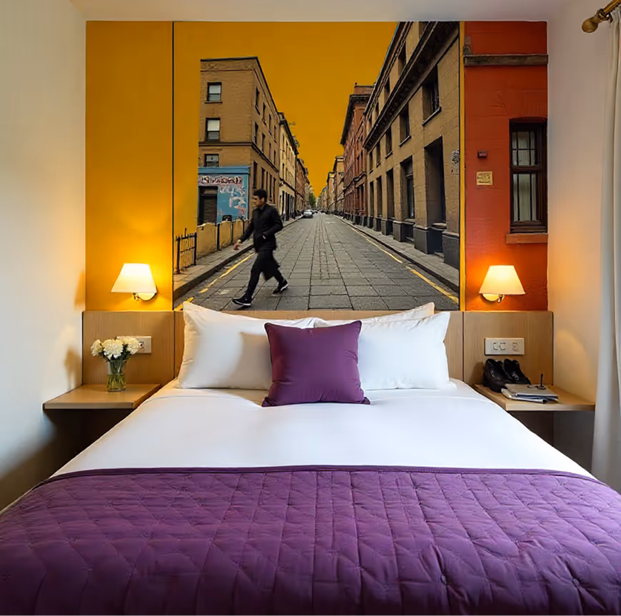 Boutique hotel room in Shoreditch featuring purple bedding and a mural of East London streetscape.