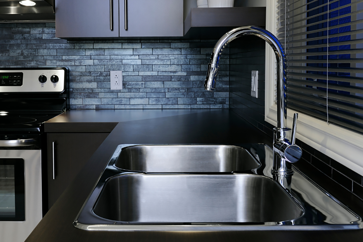 A modern double sink in a freshly renovated kitchen.