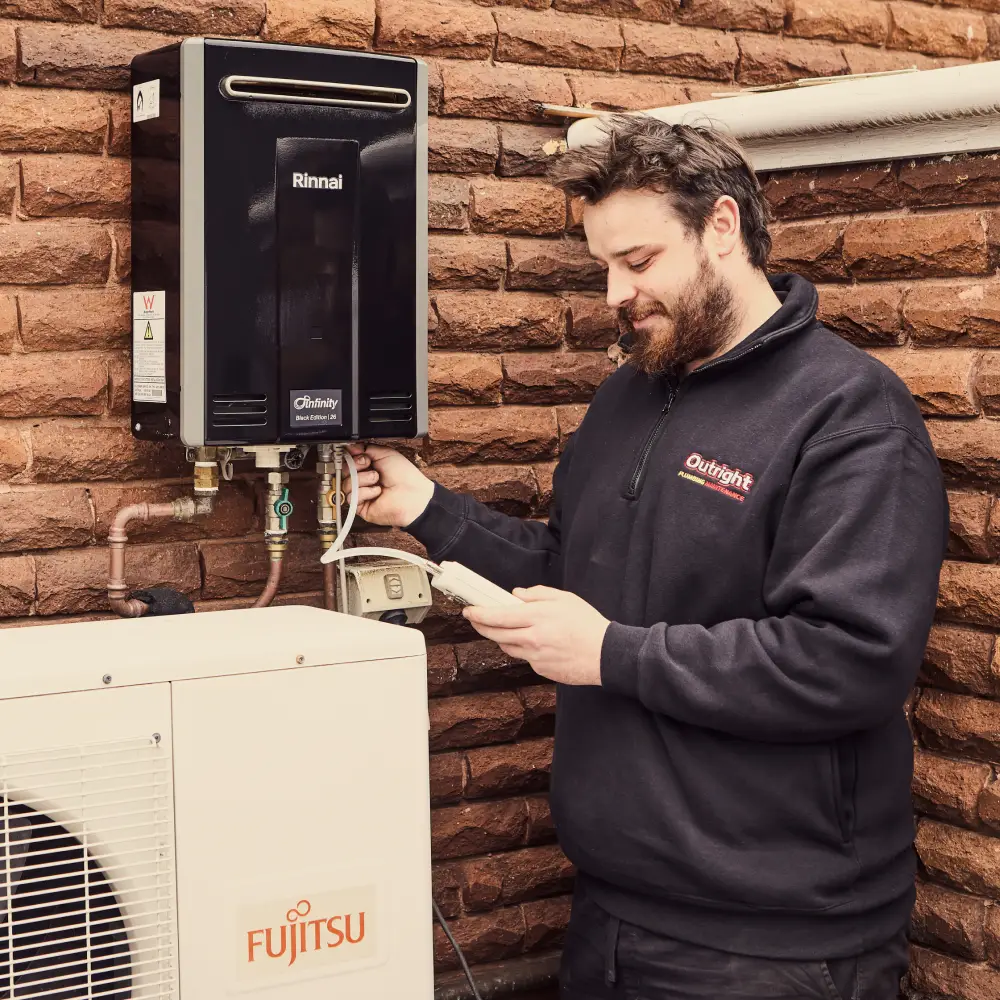 Plumber performing hot water repair service