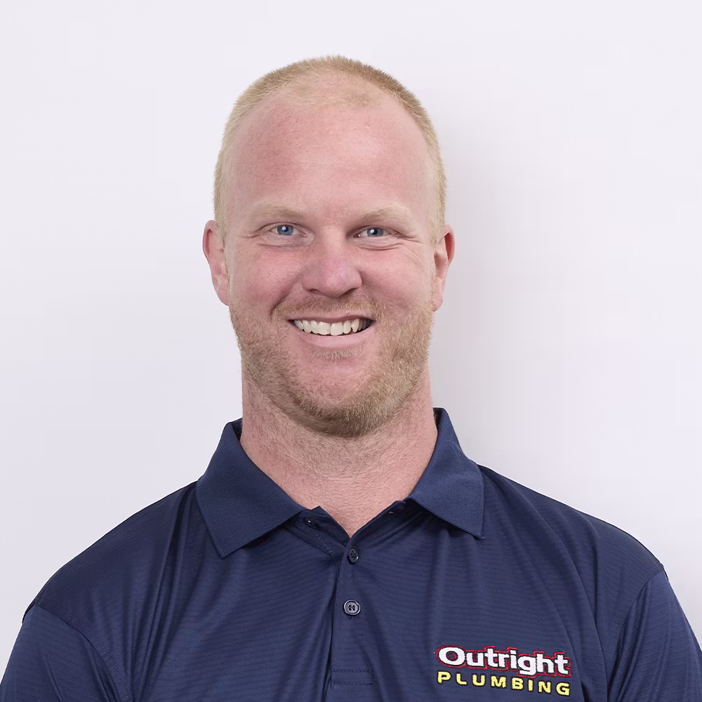 A photo of A in an Outright Plumbing uniform in a standing positionon