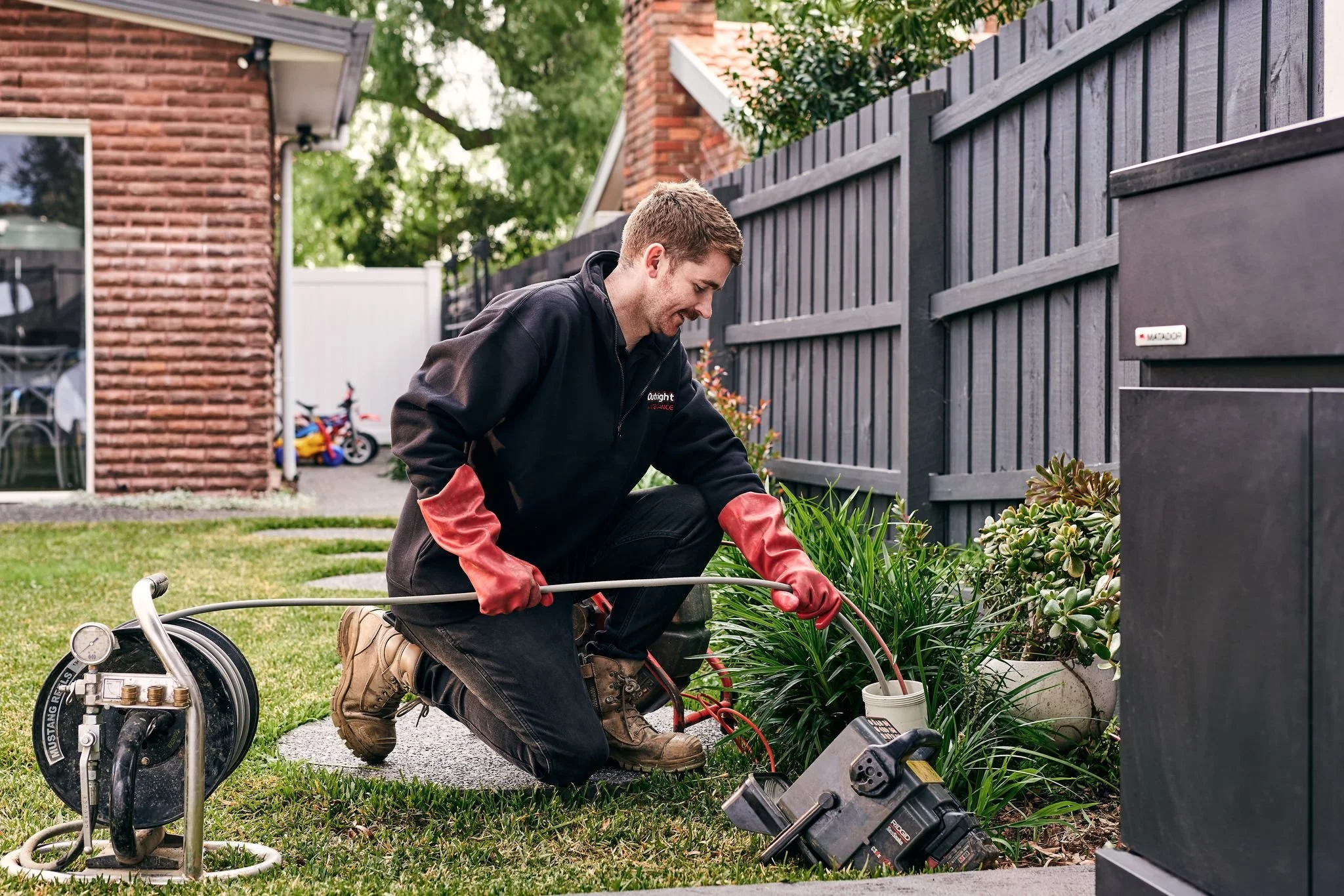 One of Outright Plumbing’s plumbers using a CCTV drain and a high-pressure hydrojet to clean the pipes of a Melbourne home.