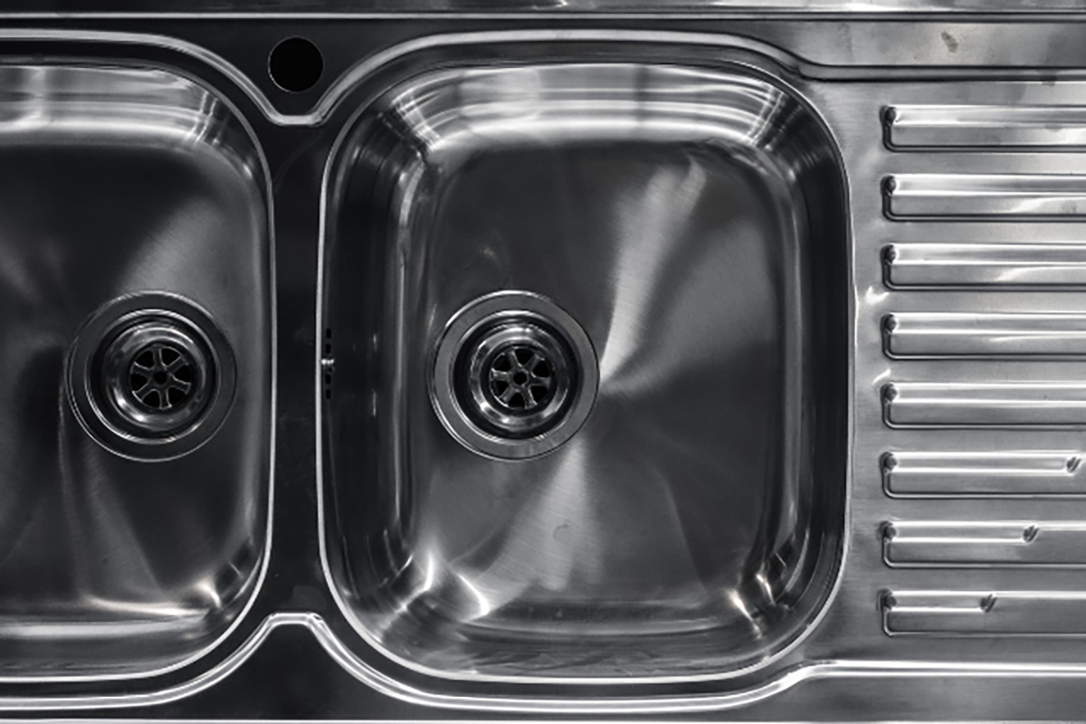Stainless steel double kitchen sink with drain holes and ribbed side panel