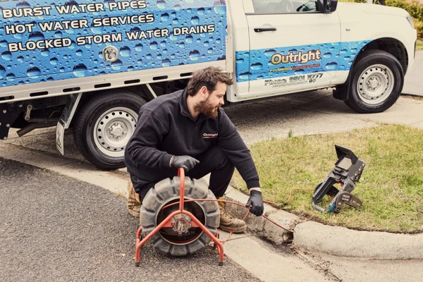 Plumber inspecting a stormwater drain