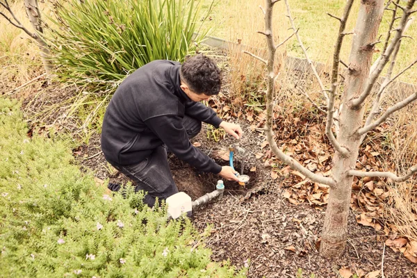 Plumber unblocking shower drain using flex shaft and cctv camering drain