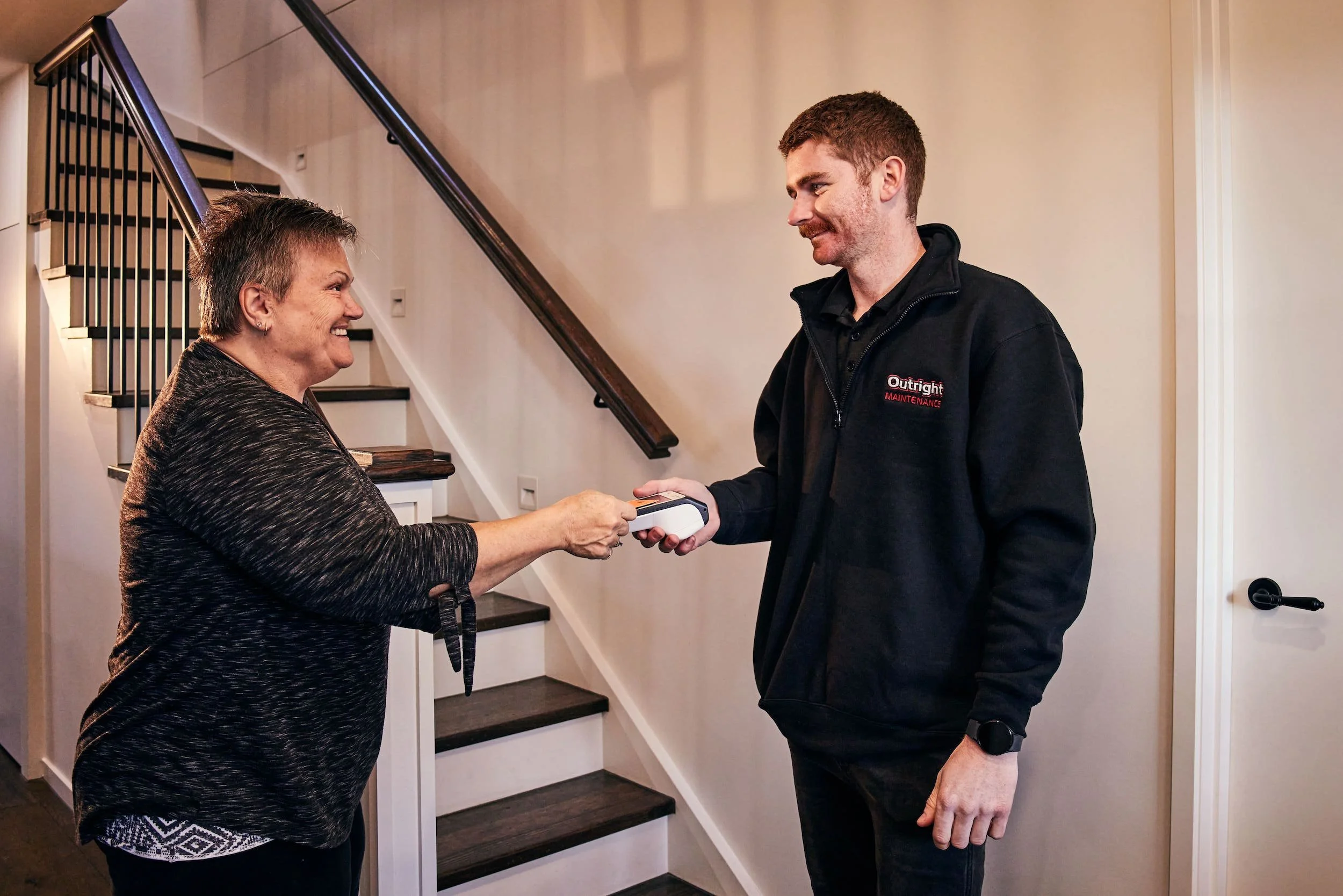 A photo of an Outright staff talking to customer