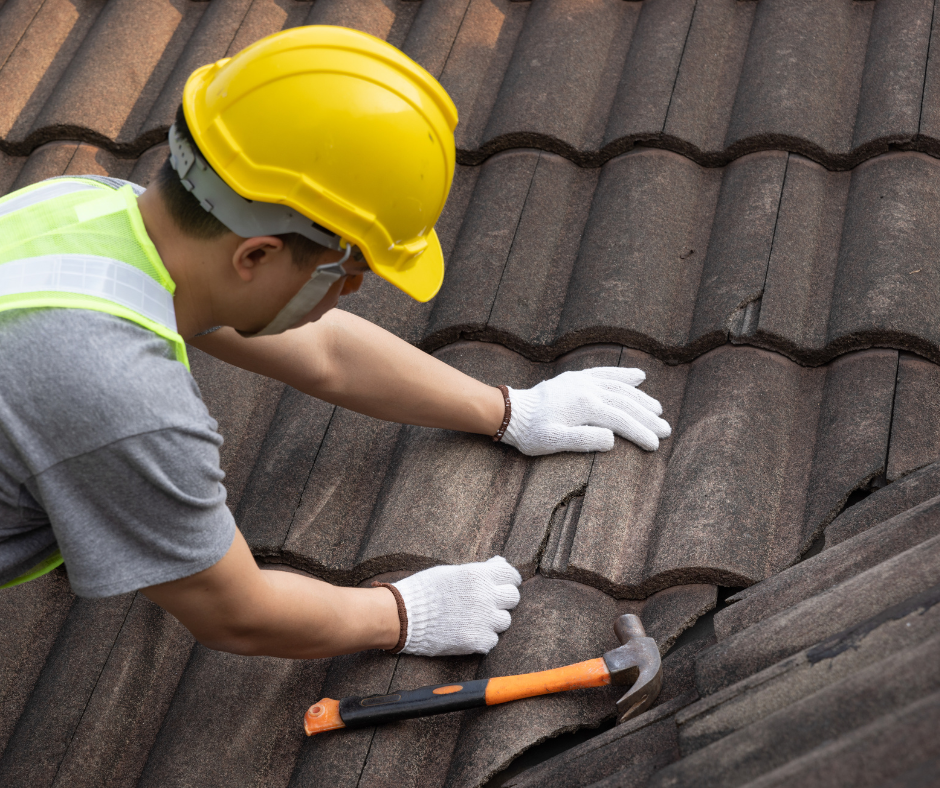 repairing broken roof tiles that cause leaks in the roof