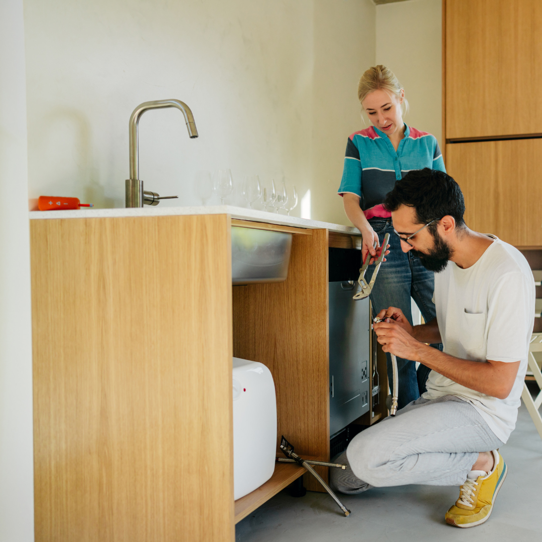 Couple DIYing their plumbing fix under their sink