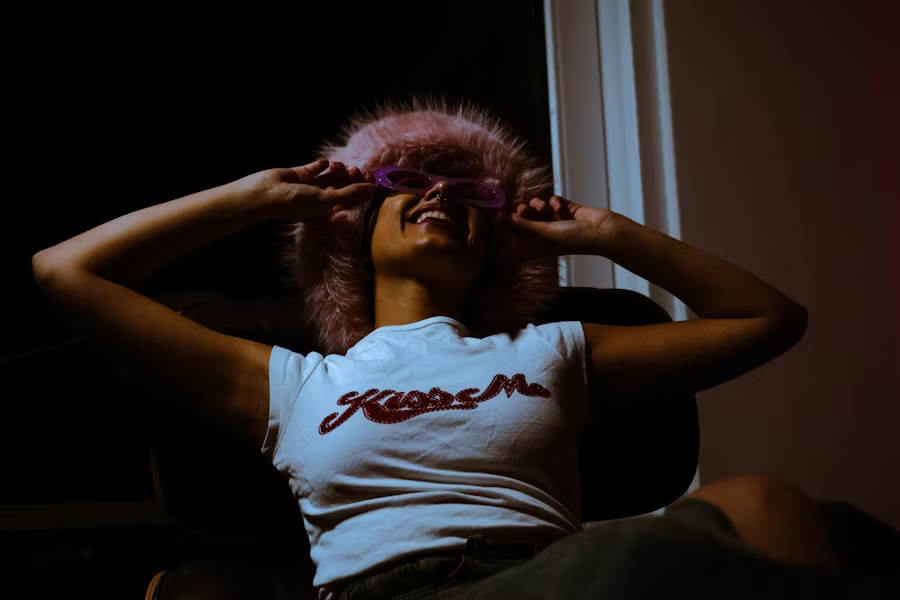 A modern laptop setup is showcased with professional lighting equipment, ideal for webcam modelling. The scene emphasizes a well-organized workspace that supports aspiring webcam models in their journey to financial freedom and success in the webcam modelling world.