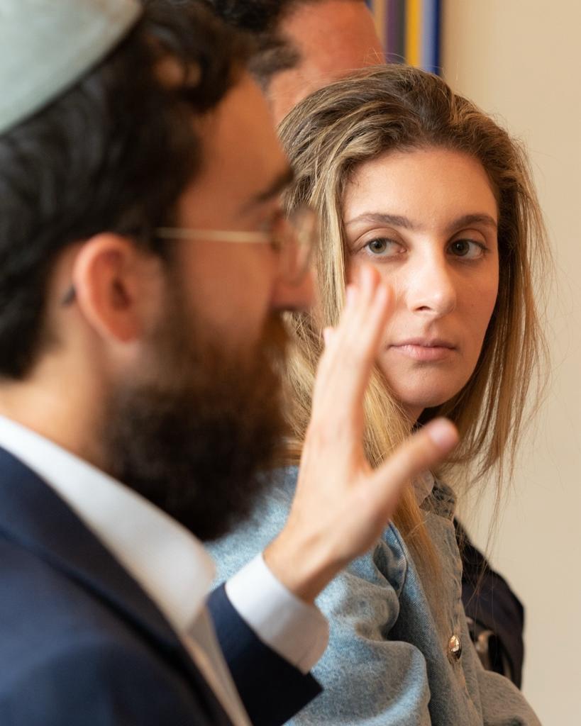 Lexi Levin looks on as Rabbi Shneor Minsky opens our 4th Lunch & Launch hosted by Paul Levy
