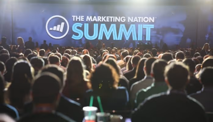 Image of Marketo's Marketing Nation logo with people networking and collaborating in the background, representing a thriving community of marketers
