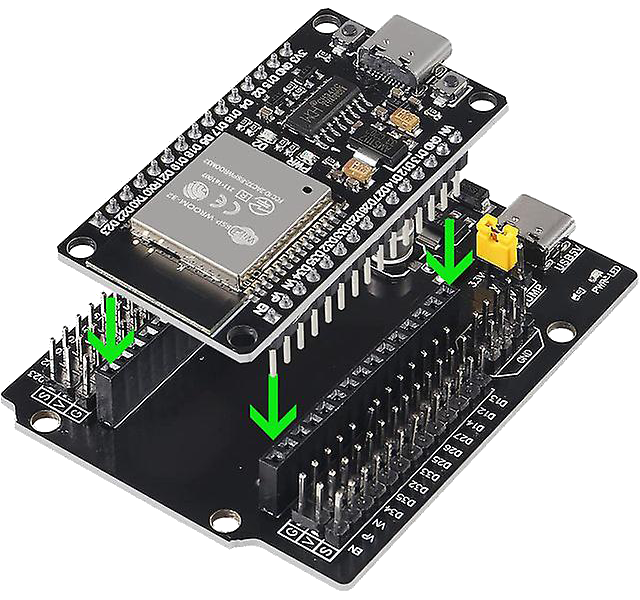 Two stacked black electronic development boards connected by pins, with green arrows indicating connection points.