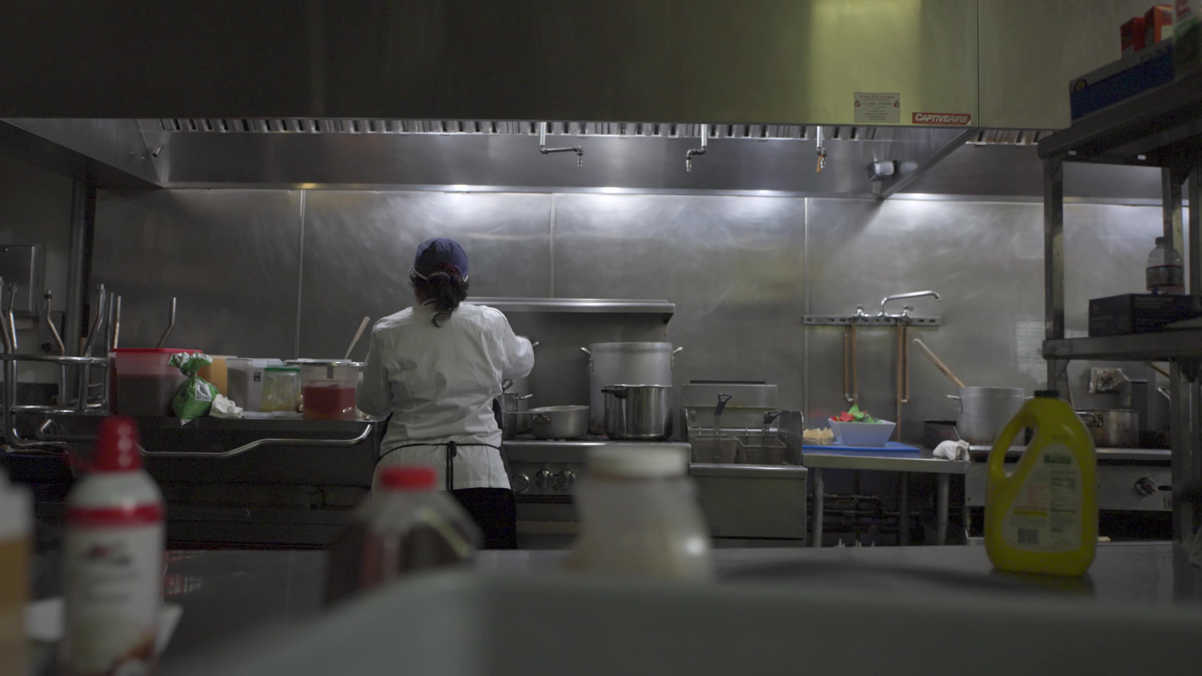 Documentary-style frame of Damiano at work in his small business