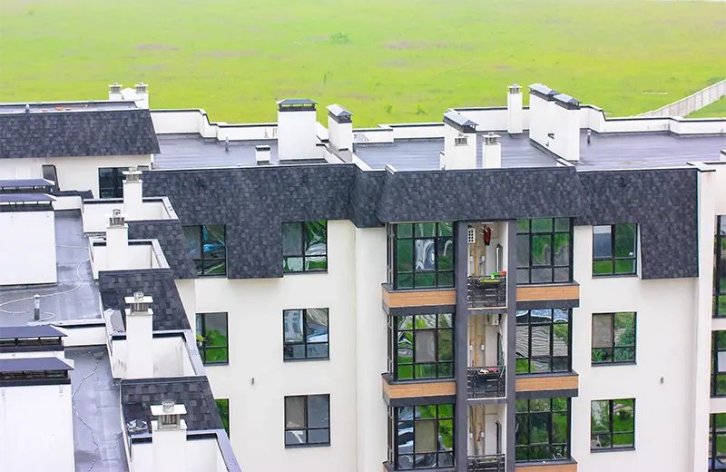 Modern multi-family apartment building with new dark shingle roof in Southlake TX
