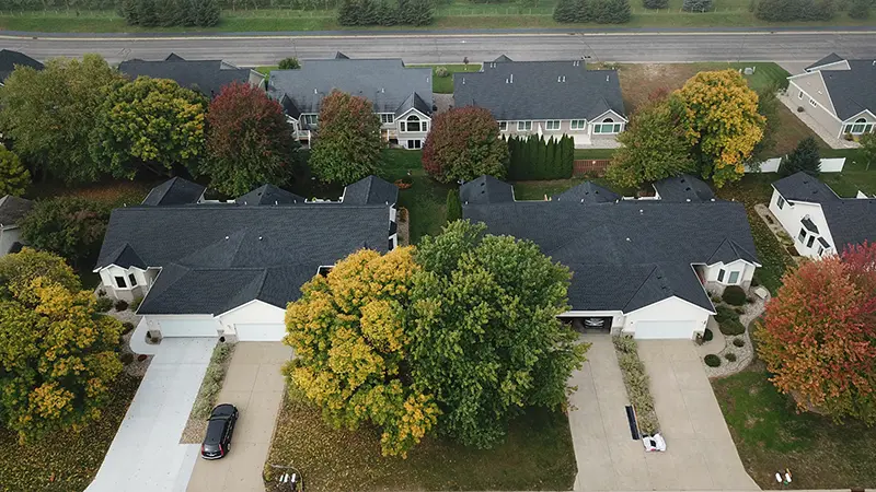 Aerial view of residential homes with newly installed shingle roofing by CLC Roofing in Southlake, TX.