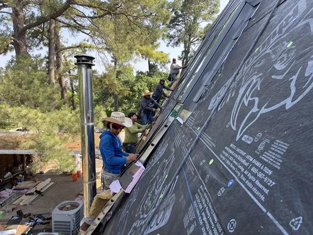 Roofing crew installing underlayment for a new metal roof in Southlake, TX, ensuring durability and long-lasting protection.