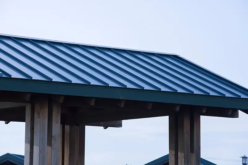 Close-up view of a blue standing seam metal roof, showcasing CLC Roofing’s precision craftsmanship and premium materials for long-lasting performance.