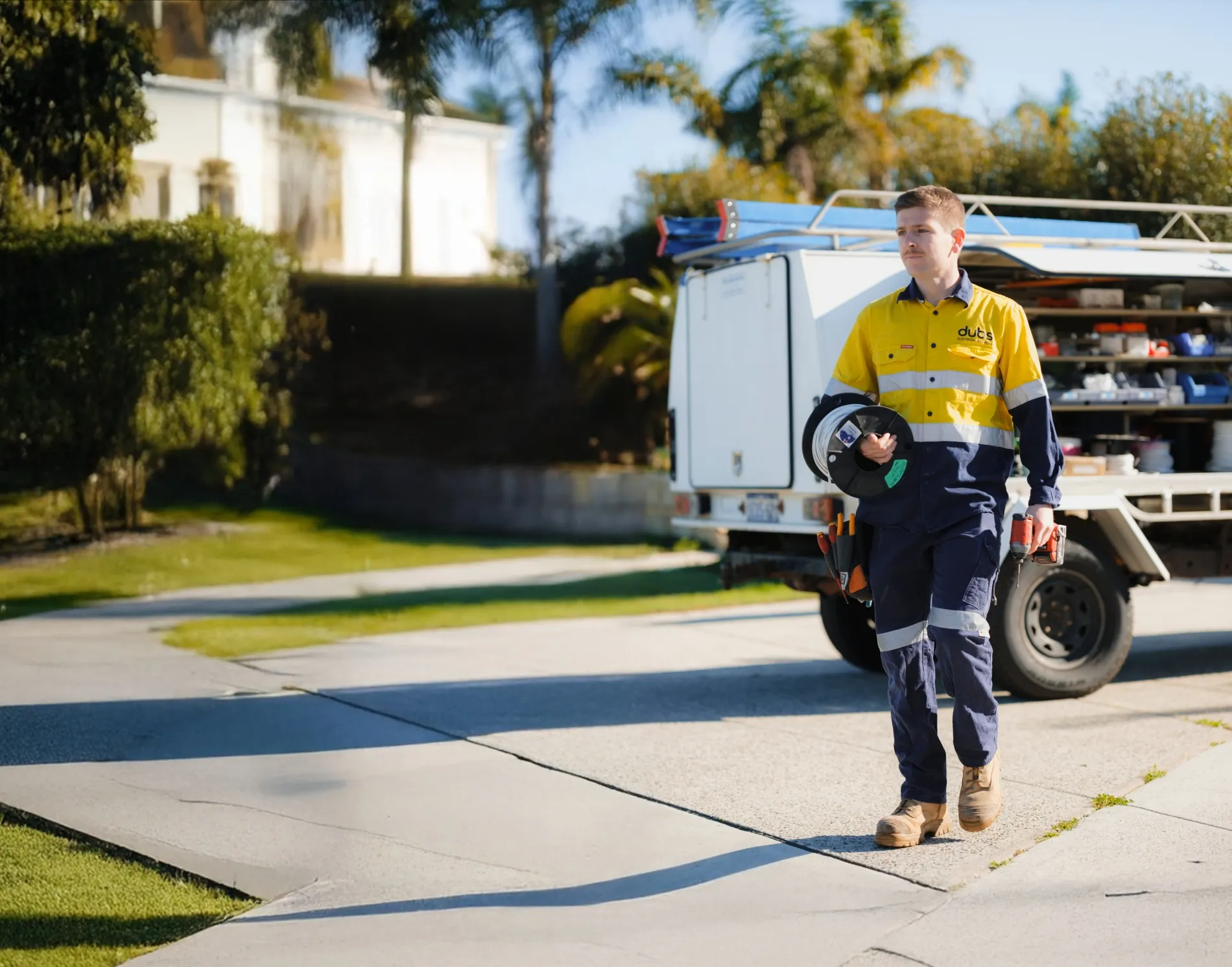 an electrician walking from his vehicle to the jobsite 