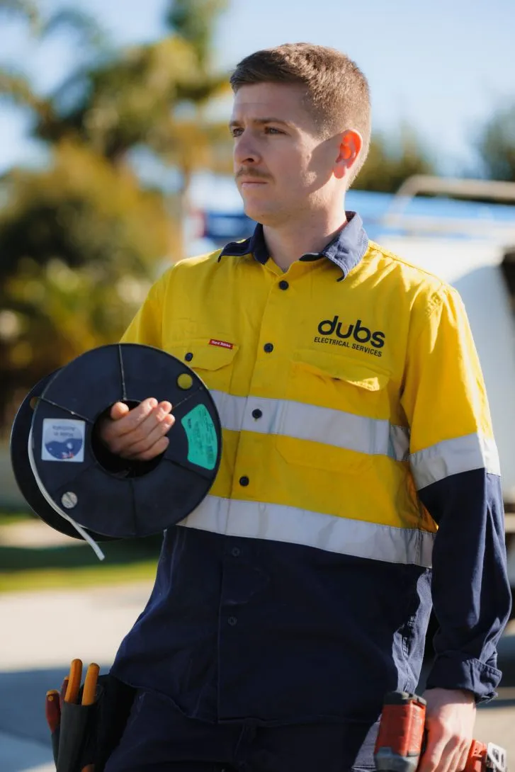 an electrician carrying some electrical cable