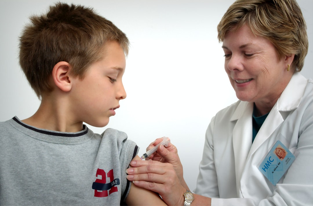 healthcare professional administering an injection to a child's arm in a friendly clinic setting - food allergy breakthrough healthcare professional administering an injection to a child's arm in a friendly clinic setting - food allergy breakthrough