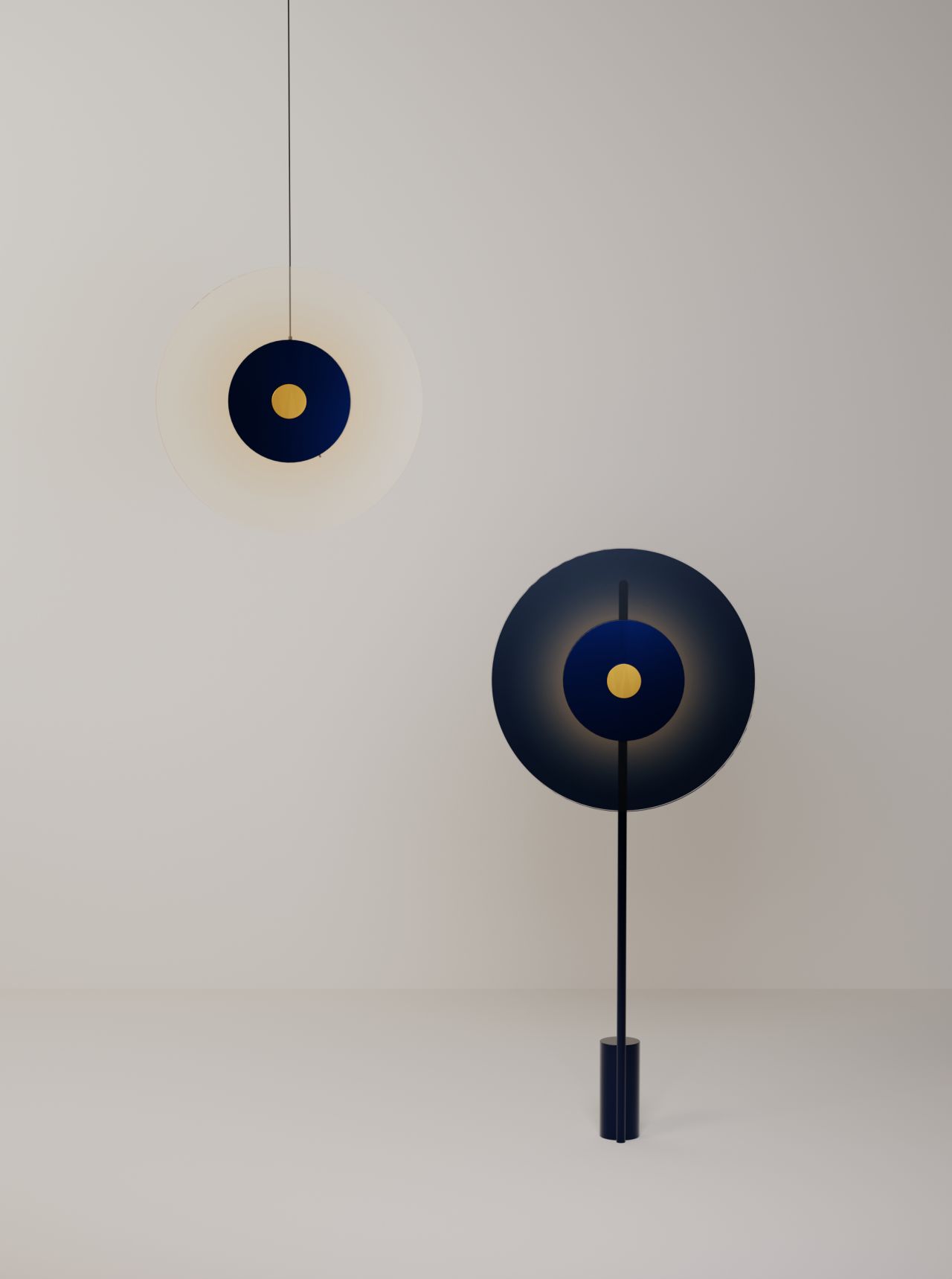 Minimalist navy blue and gold circular pendant light and floor lamp against a plain light gray wall. Leroy Merlin indoor solar lamp design innovation Laure Mimram