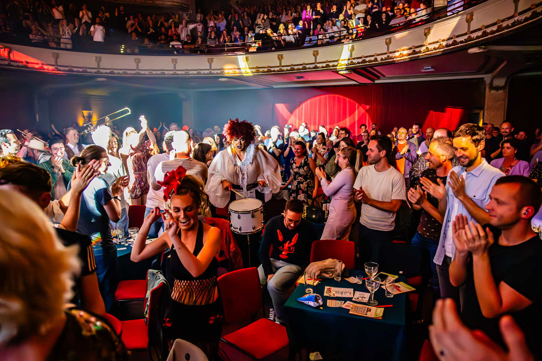 A full house at De Roma, with performers dancing and drumming in the middle of the audience as spectators clap their hands.