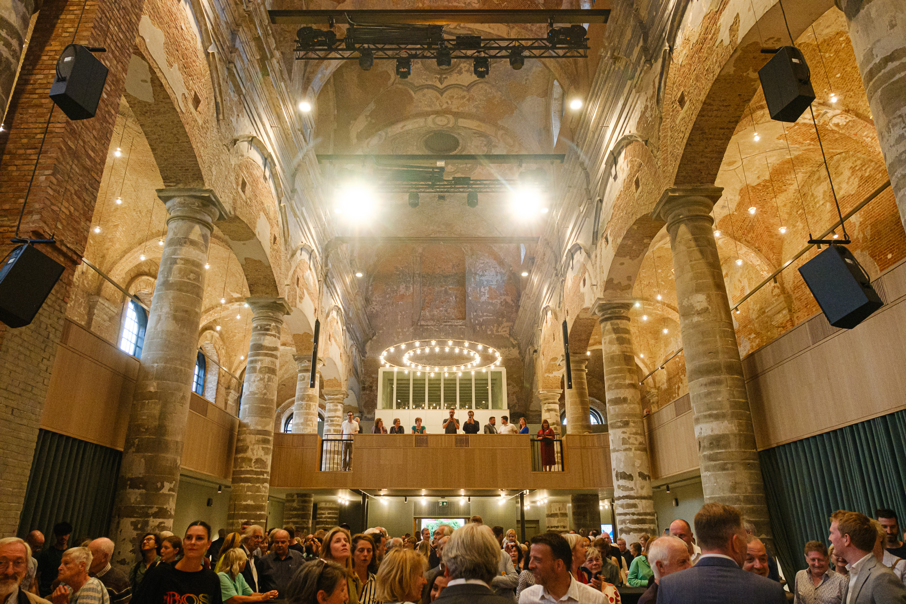 The interior of the concert hall at Het Predikheren in Mechelen, with an audience present.