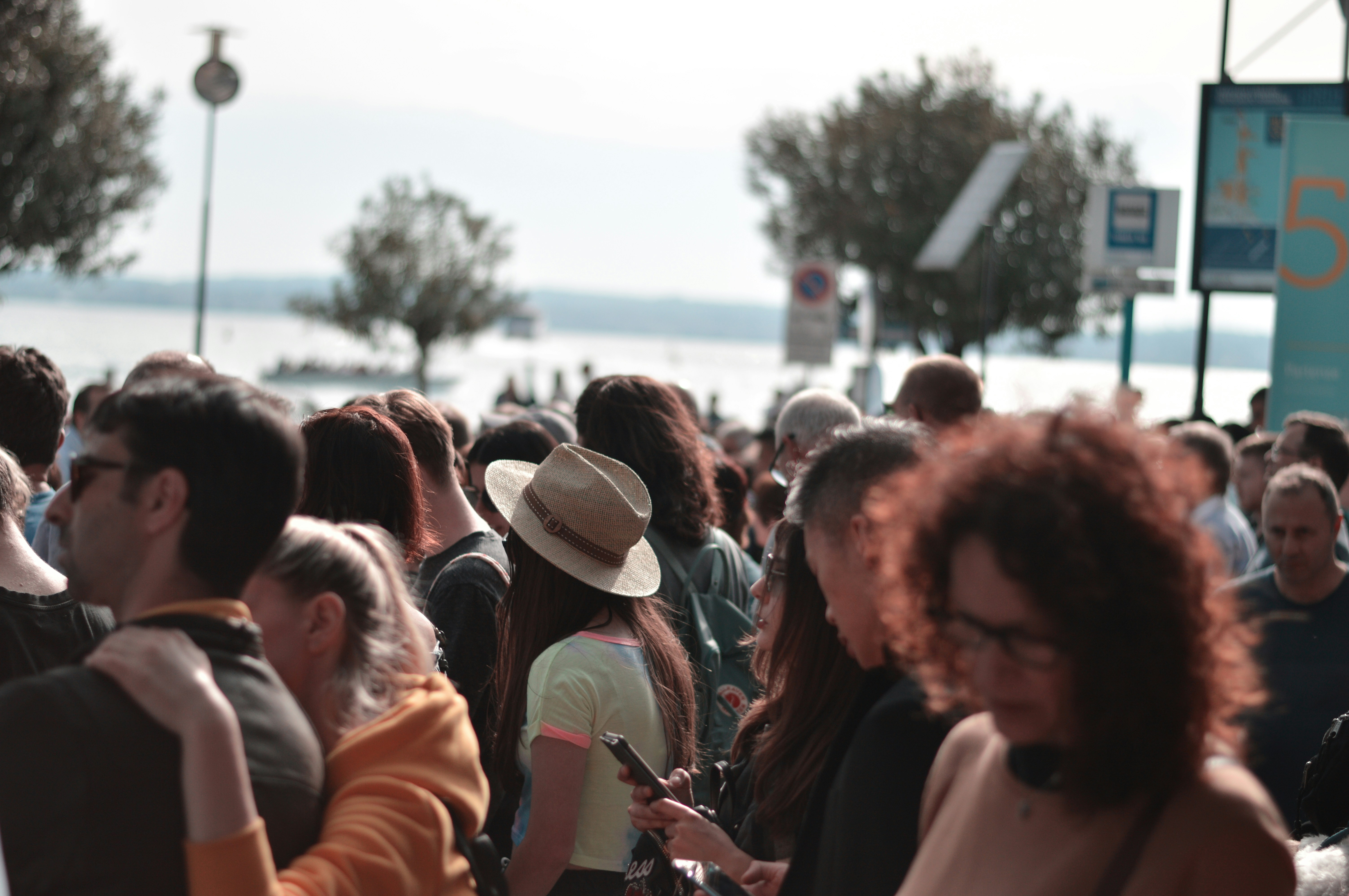 **A diverse group of visitors gathering outside before the start of a cultural event.