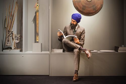 Runjeet sat in a gallery reading a brochure