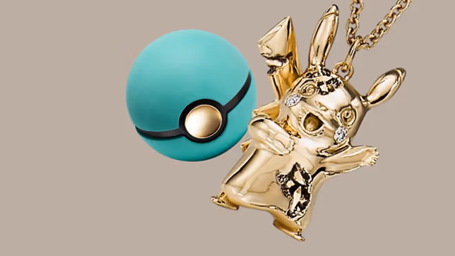 Gold Pikachu pendant with diamond-like accents hanging on a chain next to a teal Pokéball.