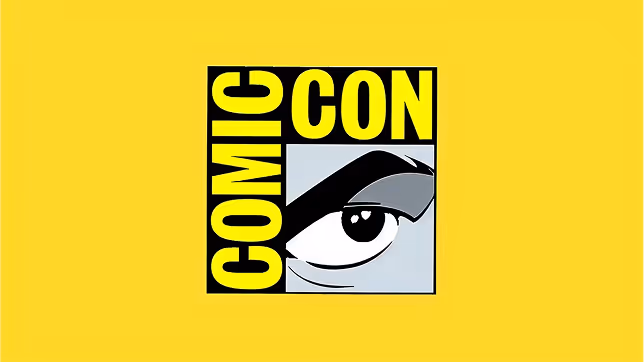 Comic Con logo with a stylized eye and bold yellow text on black squares against a yellow background.