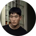Serious young Asian man with short black hair wearing a black shirt in a circular profile photo.