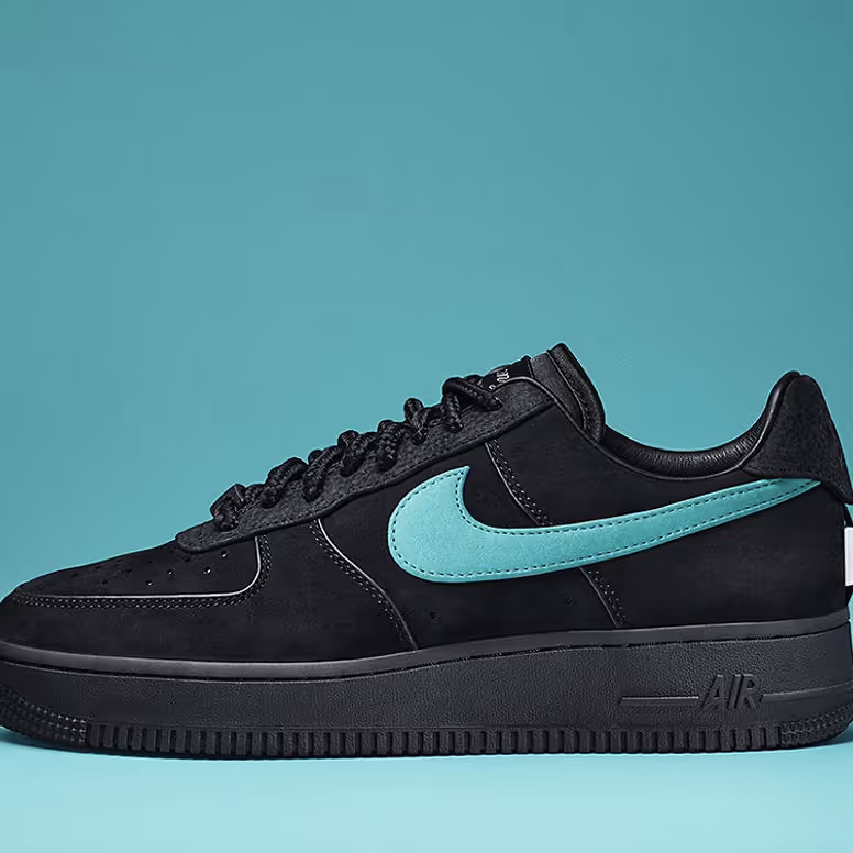 Black Nike Air Force 1 sneaker with a Tiffany blue swoosh on a matching blue background.