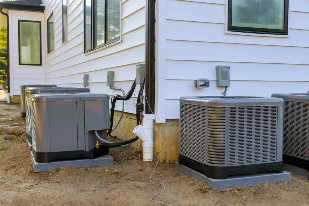 Air conditioning units installed outside a modern home, highlighting HVAC system efficiency and energy-saving potential.