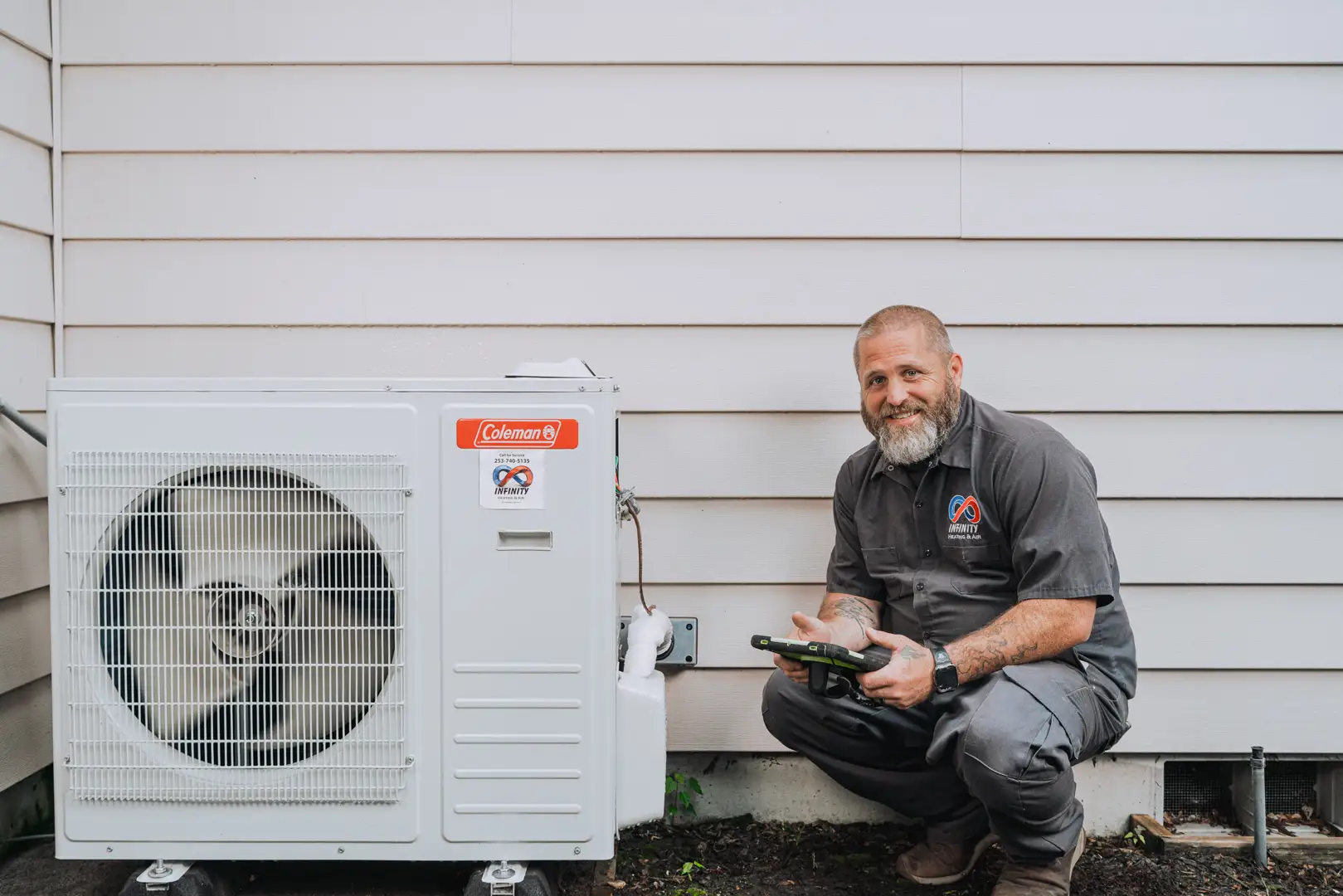 emergency heat pump pump repair Puyallup WA technician inspecting outdoor unit - emergency heat pump repair in puyallup, wa