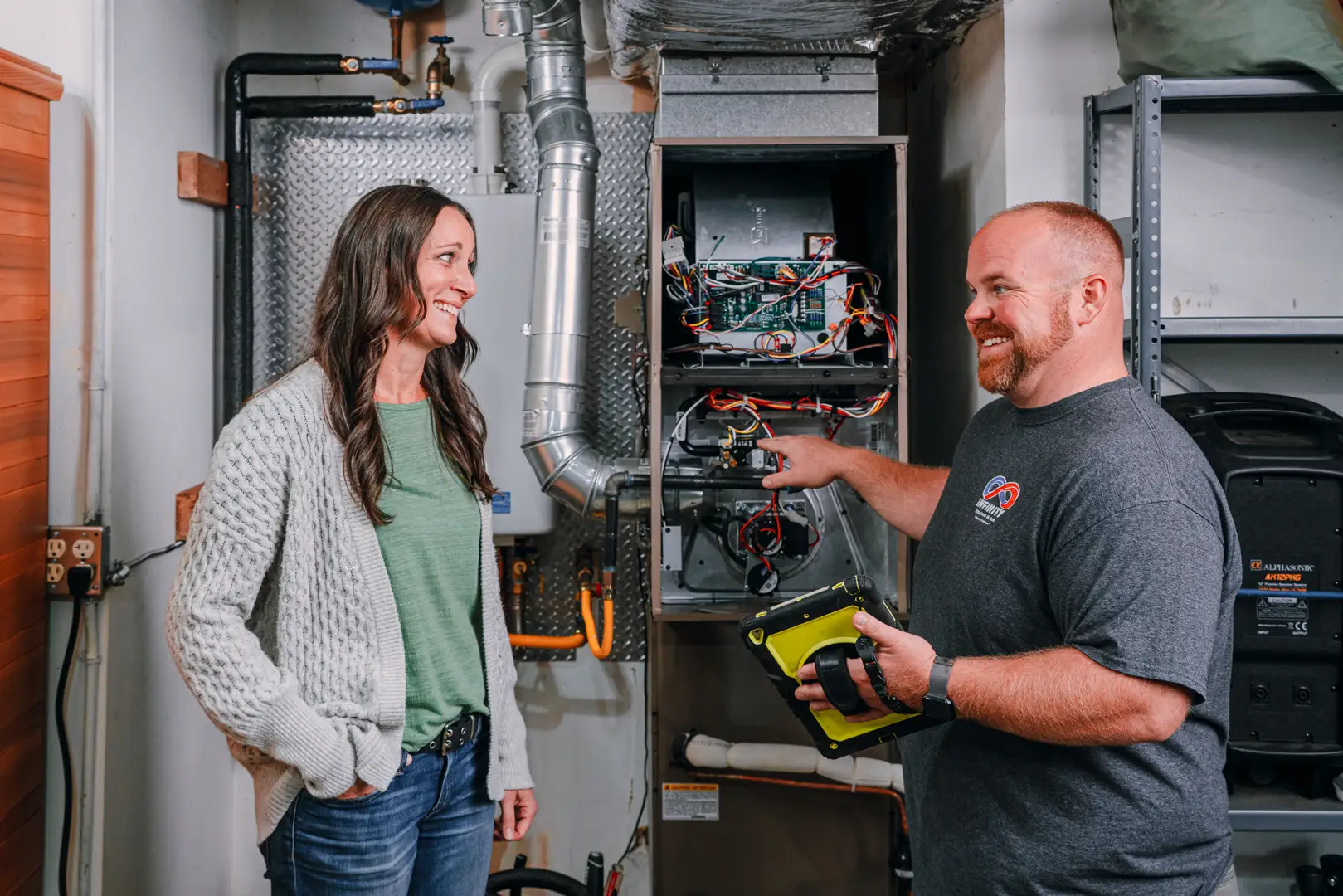 technician performing a Manual J calculation on a tablet in a home - advantages of a custom designed comfort system