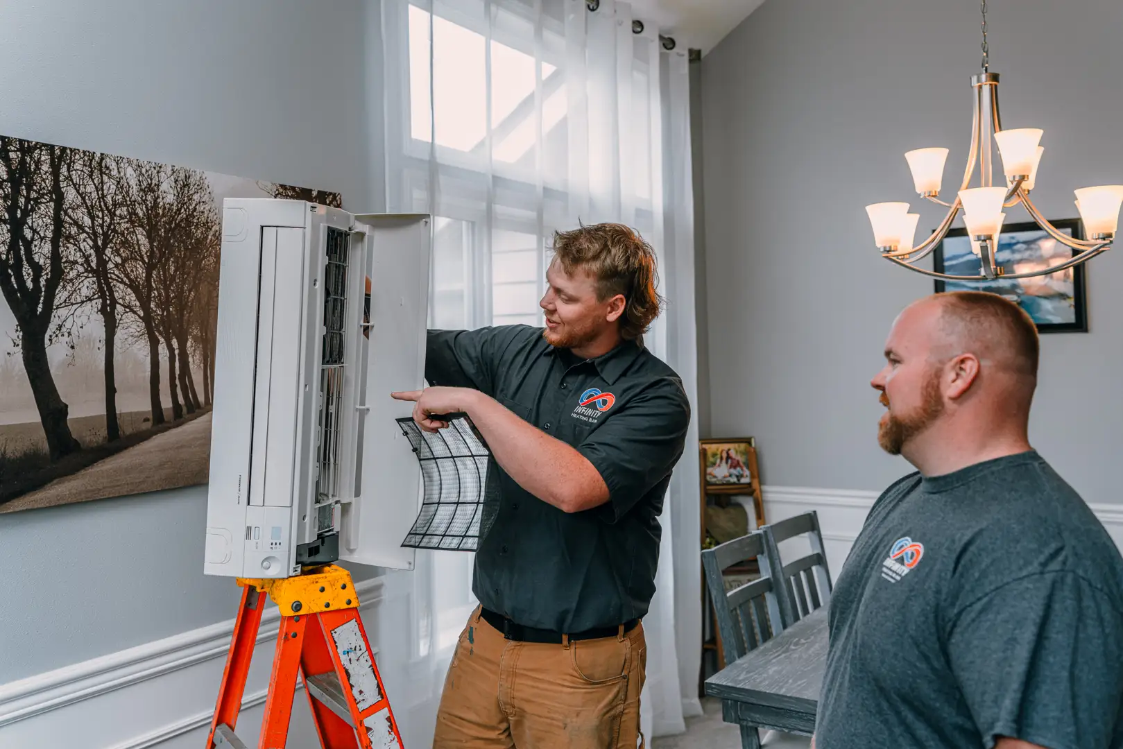 Technician inspecting an AC blower motor - ac making strange noises what they mean