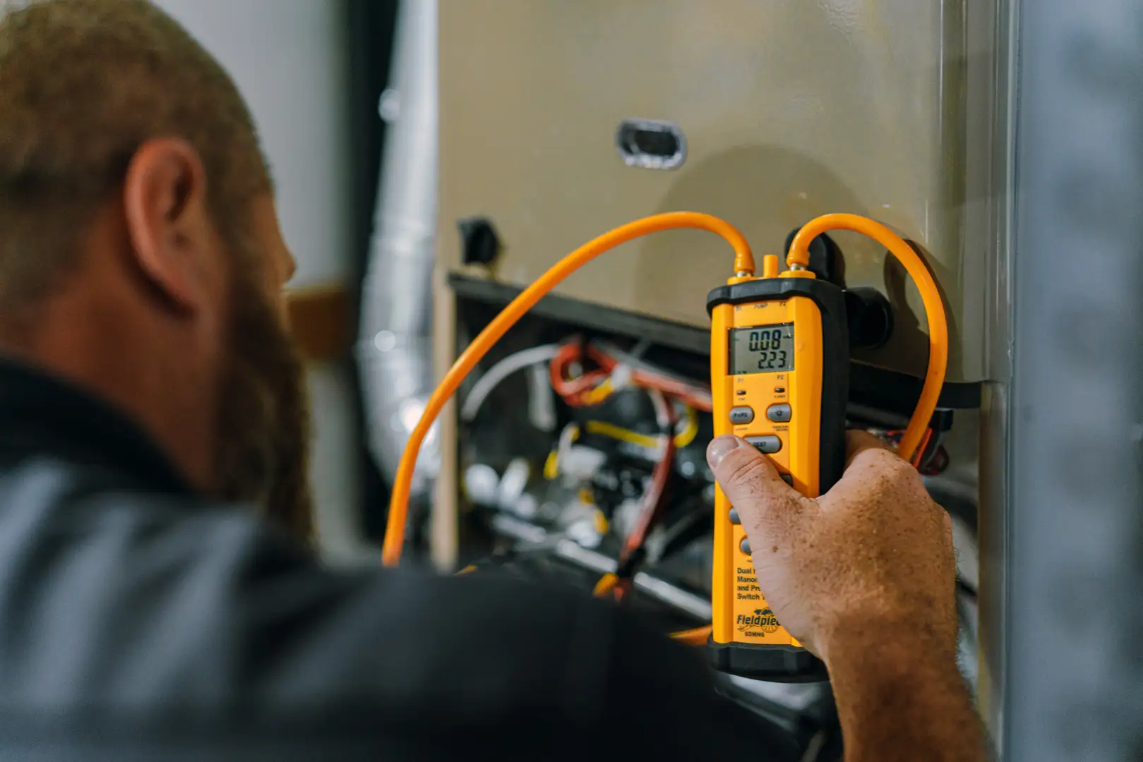 HVAC technician performing a professional Manual J load calculation in a home - adding cooling without ductwork options