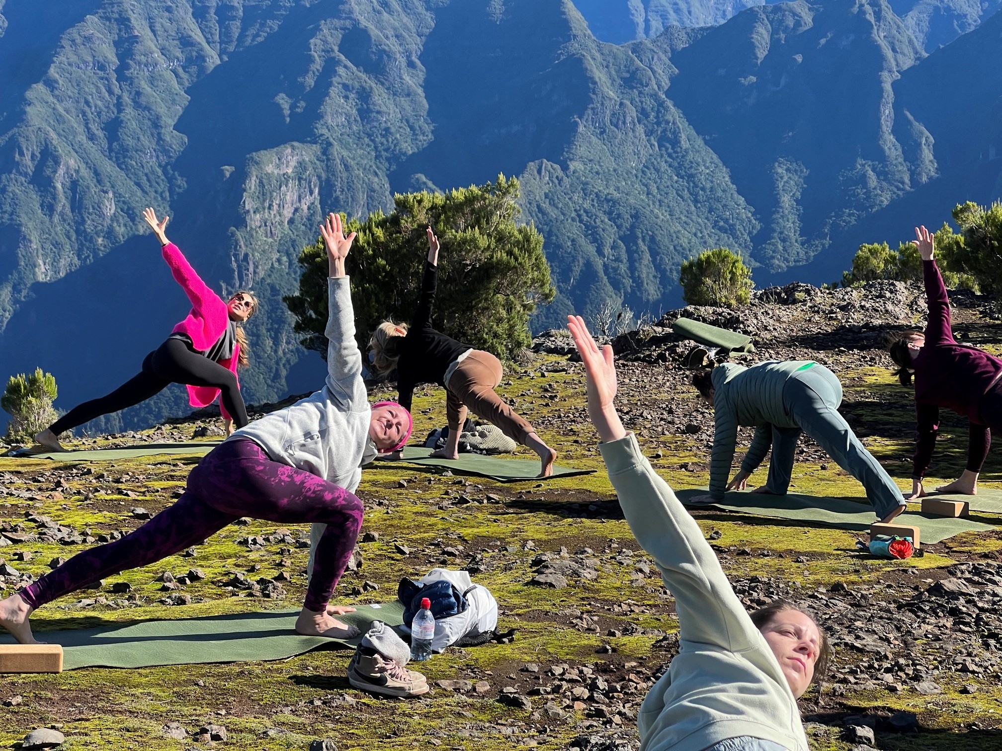 Yoga twists on a mountain top above the Madeira valleys