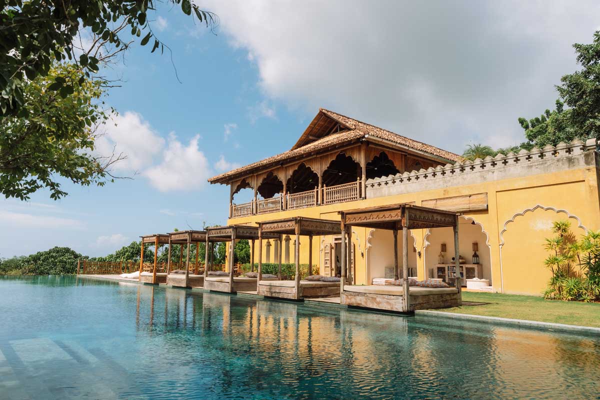 Pool pavilions beside the infinity pool and yellow-walled Hill House at Malabar Hill