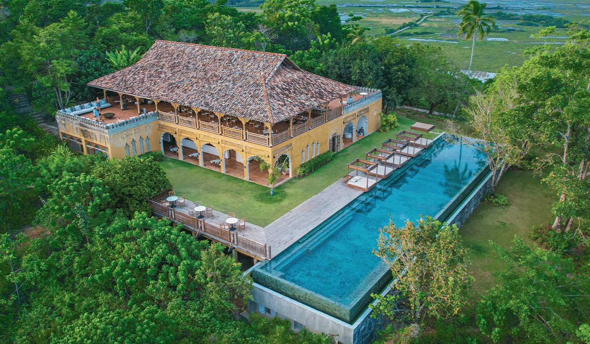 Hill House and the long infinity pool at Malabar Hill from above, surrounded by jungle and rice fields
