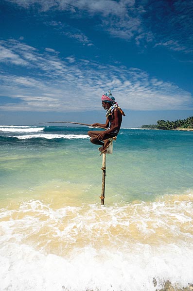 Traditional stilt fisherman in the surf on Sri Lanka's south coast