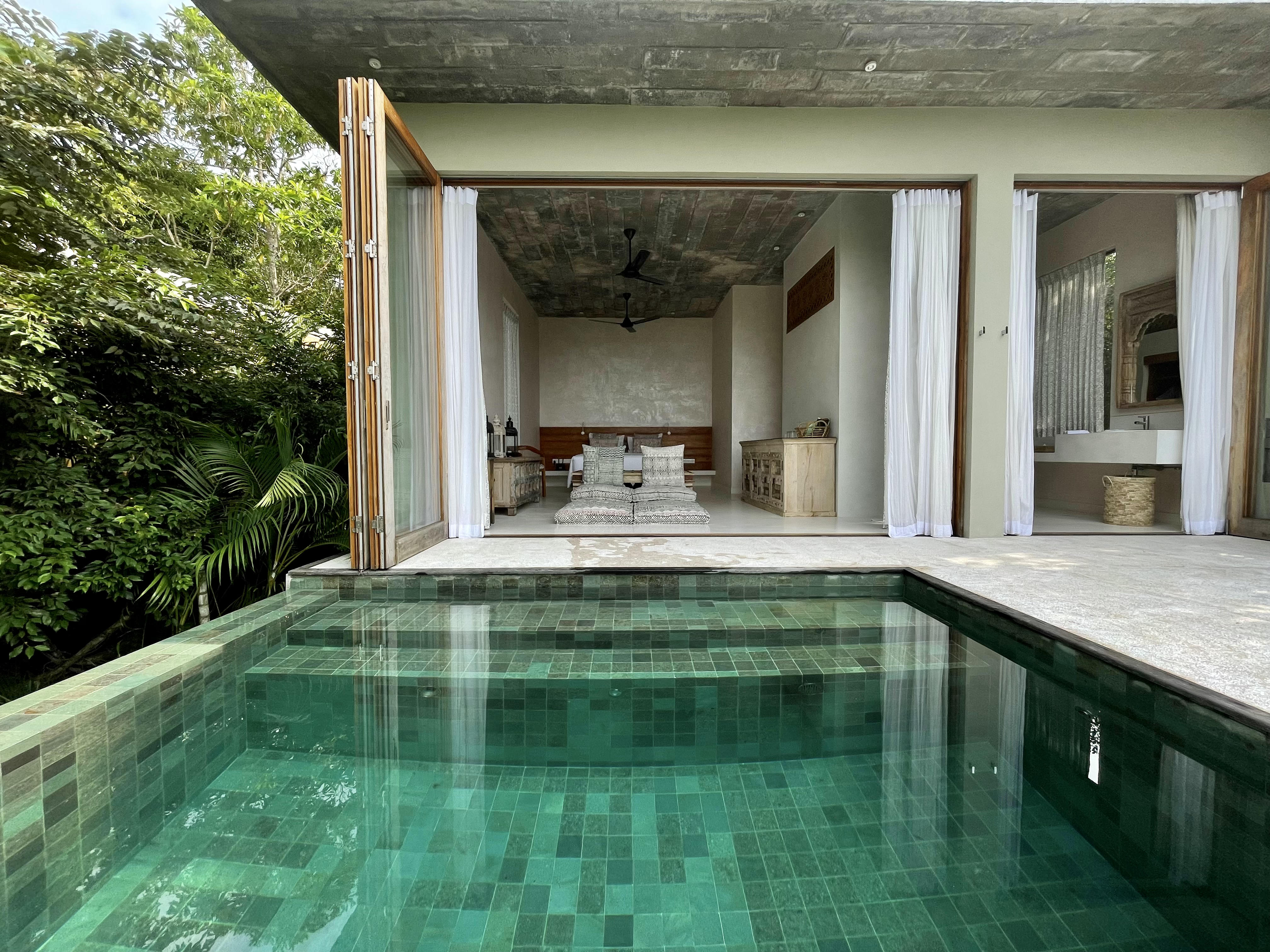 Private plunge pool opening onto a villa at Malabar Hill, surrounded by jungle