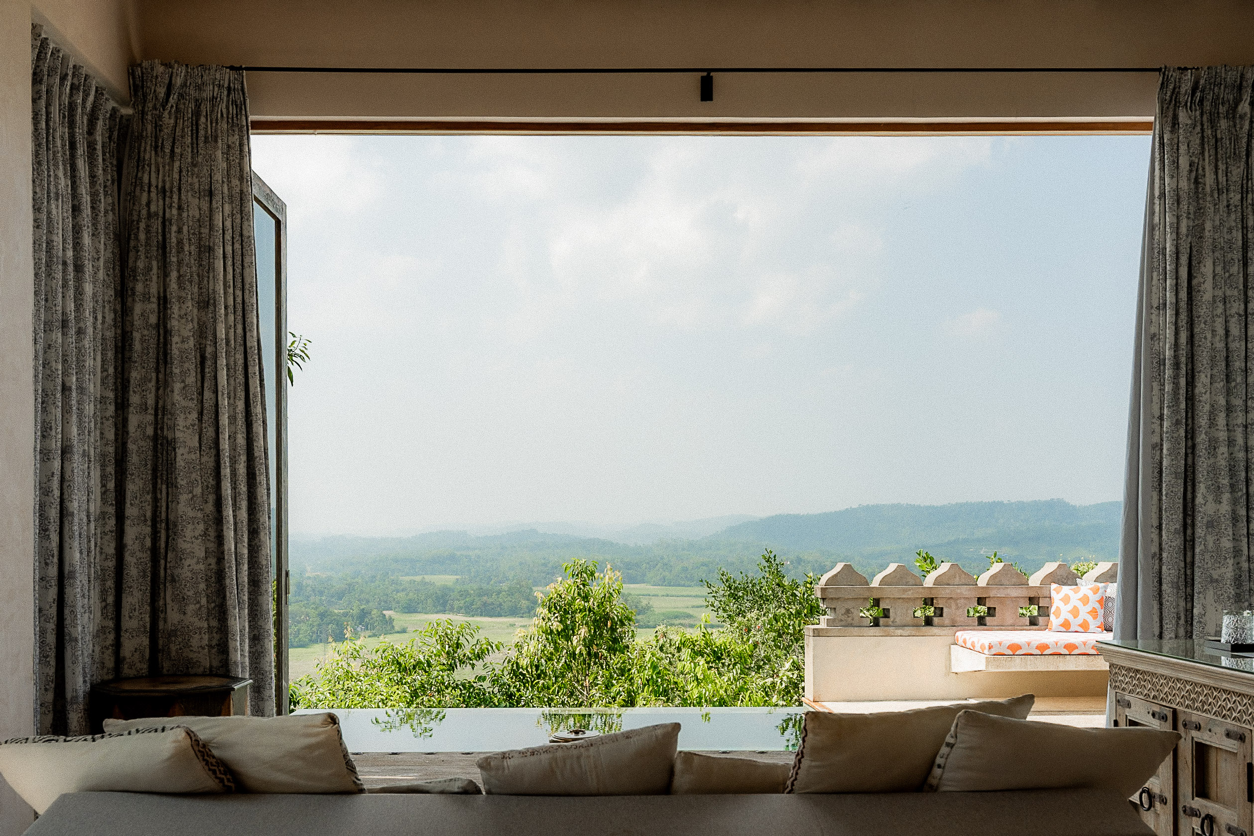 A daybed looking out over the jungle-covered hills from a villa at Malabar Hill