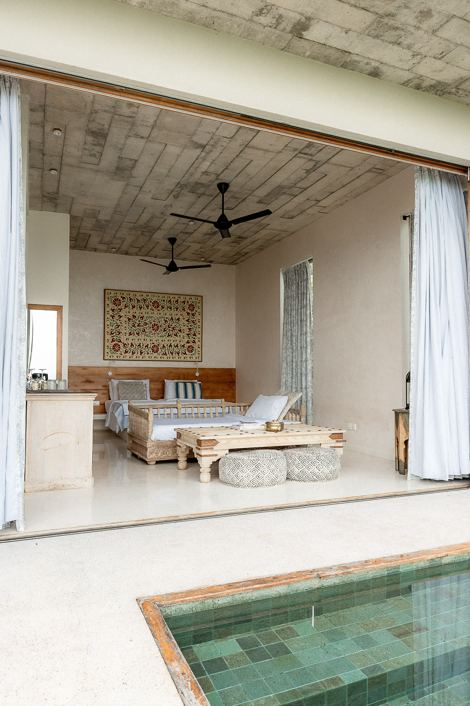 A villa bedroom at Malabar Hill opening straight onto its private plunge pool