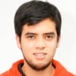 Young man with short dark hair and light beard wearing a red hoodie, smiling slightly at the camera.