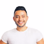 Smiling man with short dark hair and trimmed beard wearing a white t-shirt.
