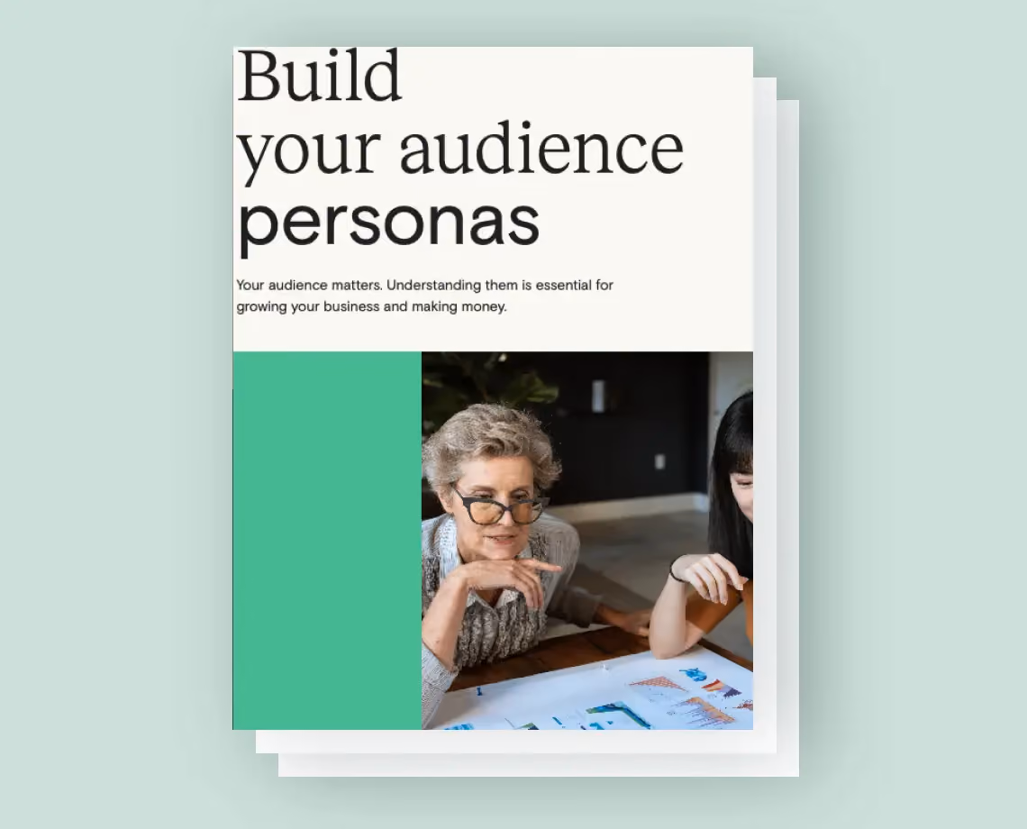 Older woman and younger woman discussing documents with charts on a table about audience personas.