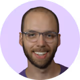 A man with a beard and glasses smiling for the camera.