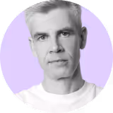 A man with blonde hair and a white shirt.