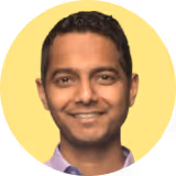 A man with a smile on his face and a yellow circle around him.